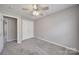 Bedroom with neutral walls, plush carpet, and standard-sized closet at 115 Scotch Irish Ln, Troutman, NC 28166