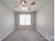 Bedroom with neutral walls, carpet floors, a ceiling fan and a bright window at 115 Scotch Irish Ln, Troutman, NC 28166