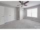Bedroom featuring carpeted floors, closet space, and natural light from the window at 115 Scotch Irish Ln, Troutman, NC 28166