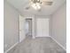 Bedroom with neutral walls, plush carpet, and standard-sized closet at 115 Scotch Irish Ln, Troutman, NC 28166