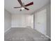 Bedroom with carpet floors, a ceiling fan, double door closet and ensuite bathroom access at 115 Scotch Irish Ln, Troutman, NC 28166