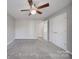 Spacious bedroom features plush carpeting, neutral paint, and a ceiling fan at 115 Scotch Irish Ln, Troutman, NC 28166
