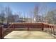 Wooden deck with railings overlooking the landscape with some snow at 115 Scotch Irish Ln, Troutman, NC 28166