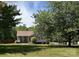 Attractive single-story house surrounded by mature trees and a lush green lawn at 115 Scotch Irish Ln, Troutman, NC 28166