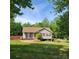 Charming single-story home with a well-maintained lawn, red shutters, and a cozy front porch at 115 Scotch Irish Ln, Troutman, NC 28166
