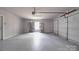 Spacious garage with ample storage and a neutral color palette offers functionality and organization at 115 Scotch Irish Ln, Troutman, NC 28166