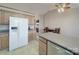 Open kitchen area featuring a refrigerator, cabinets, and view to the dining area and fireplace at 115 Scotch Irish Ln, Troutman, NC 28166