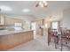 Bright kitchen connecting to dining space, featuring white appliances and plentiful cabinet storage at 115 Scotch Irish Ln, Troutman, NC 28166