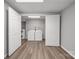 Bright laundry room with a washer and dryer, wood-look floor, and ample space at 115 Scotch Irish Ln, Troutman, NC 28166