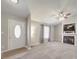 Bright living room featuring a ceiling fan, fireplace with built-in shelves, and a window with curtains at 115 Scotch Irish Ln, Troutman, NC 28166