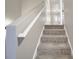Carpeted staircase with gray walls and a white railing at 115 Scotch Irish Ln, Troutman, NC 28166