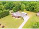 Expansive aerial view of a well-maintained property with lush greenery and a long driveway at 119 Era St, Troutman, NC 28166