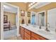 Bathroom with double vanity with wood cabinets, and views of a connected bedroom and an adjacent shower area at 119 Era St, Troutman, NC 28166