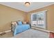 Cozy guest bedroom with a bright blue patterned quilt, a window, neutral walls, and a ceiling fan at 119 Era St, Troutman, NC 28166