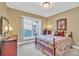 Cozy bedroom with floral bedding, two dressers and a window view at 119 Era St, Troutman, NC 28166
