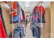 Walk-in closet offers plenty of space for storage on multiple shelves and clothing racks at 119 Era St, Troutman, NC 28166