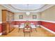 Formal dining room boasts decorative lighting fixture, wood furniture, and bright red accent wall at 119 Era St, Troutman, NC 28166