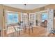 Light-filled dining room with hardwood floors, glass table, and multiple doors leading to additional spaces at 119 Era St, Troutman, NC 28166