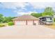 Spacious garage with RV parking, offering ample space for vehicles and storage, with a long driveway at 119 Era St, Troutman, NC 28166