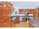 Spacious kitchen featuring hardwood floors, granite countertops, stainless appliances, and wooden cabinets at 119 Era St, Troutman, NC 28166