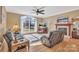 Bright living room with hardwood floors, large windows, and a cozy fireplace at 119 Era St, Troutman, NC 28166