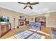 Spacious living room with hardwood floors, fireplace, and views into the kitchen and dining areas at 119 Era St, Troutman, NC 28166