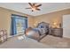 Comfortable primary bedroom with ceiling fan, carpet, and large window at 119 Era St, Troutman, NC 28166