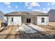 Enjoy outdoor living on the covered back patio, with a fan, sliding doors, and a concrete floor at 127 Tradesmen Trl, Troutman, NC 28166
