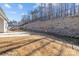 Large backyard with retaining wall, offering plenty of space for recreation and relaxation at 127 Tradesmen Trl, Troutman, NC 28166