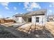 Great outdoor space featuring a covered patio, sliding doors, and a well-maintained lawn at 127 Tradesmen Trl, Troutman, NC 28166