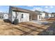 View of the back of the home with patio and backyard area with an AC unit on the side of the home at 127 Tradesmen Trl, Troutman, NC 28166