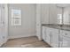Bright bathroom with granite countertops, modern vanity, and a large window at 127 Tradesmen Trl, Troutman, NC 28166