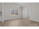 Sunny dining room with a chandelier, large window, and view into an adjacent room at 127 Tradesmen Trl, Troutman, NC 28166