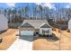 Charming single-story home with stone accents, two-car garage, and a well-manicured front yard at 127 Tradesmen Trl, Troutman, NC 28166