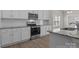 Charming kitchen features white cabinets, stainless steel appliances, granite countertops, subway tile backsplash, and wood-look flooring at 127 Tradesmen Trl, Troutman, NC 28166