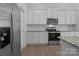 Bright kitchen with stainless steel refrigerator, microwave, oven and white cabinets; great counter space and subway tile backsplash at 127 Tradesmen Trl, Troutman, NC 28166