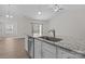 View of kitchen island with stainless steel sink and dishwasher with open view to dining area at 127 Tradesmen Trl, Troutman, NC 28166