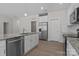 Modern kitchen with granite countertops, stainless steel appliances, and white cabinets at 127 Tradesmen Trl, Troutman, NC 28166