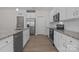 Modern kitchen featuring stainless steel appliances, granite countertops, and bright white cabinetry at 127 Tradesmen Trl, Troutman, NC 28166