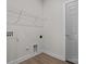 Laundry room featuring clean white walls, a wire rack shelf, and modern gray door at 127 Tradesmen Trl, Troutman, NC 28166