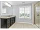 Bathroom with tiled floor, granite countertop vanity, large window, and glass-enclosed shower at 14125 Derby Farm Ln, Charlotte, NC 28278