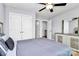 A cozy bedroom features neutral walls, double door closet, ceiling fan, and dresser with mirror at 14125 Derby Farm Ln, Charlotte, NC 28278