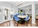 Bright dining area with hardwood floors, stylish light fixture, and door to patio at 14125 Derby Farm Ln, Charlotte, NC 28278