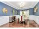 Formal dining room features elegant lighting, wainscoting, and ample space for entertaining at 14125 Derby Farm Ln, Charlotte, NC 28278