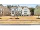 Striking two-story home boasts manicured lawn, stone accents, and a welcoming front porch, showcasing curb appeal at 14125 Derby Farm Ln, Charlotte, NC 28278
