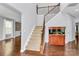 Bright foyer with hardwood floors, staircase with metal spindles, and fish tank at 14125 Derby Farm Ln, Charlotte, NC 28278