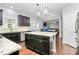 Modern kitchen boasts granite countertops, black cabinets, and stainless steel appliances at 14125 Derby Farm Ln, Charlotte, NC 28278