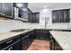 Modern kitchen with granite countertops, stainless steel appliances, gas cooktop and dark cabinets at 14125 Derby Farm Ln, Charlotte, NC 28278