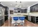 Modern kitchen with stainless steel appliances, white backsplash and counter seating at 14125 Derby Farm Ln, Charlotte, NC 28278