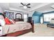 Bright main bedroom with tray ceiling, dark wood furniture, and ensuite bathroom at 14125 Derby Farm Ln, Charlotte, NC 28278